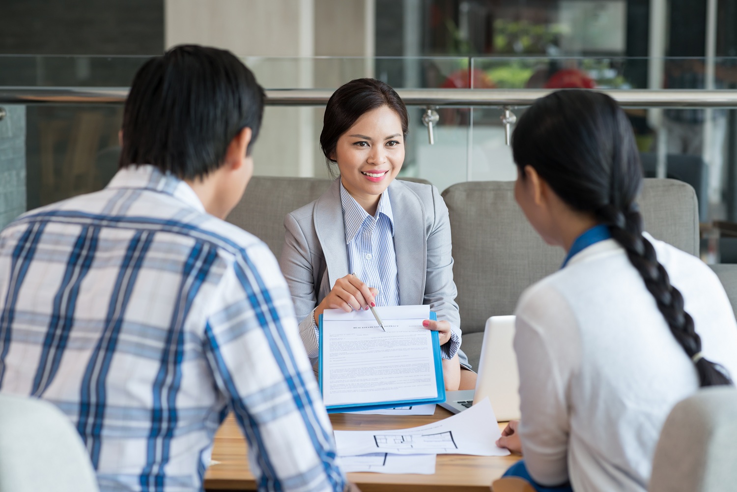 Homebuyers reviewing mortgage information with a professional